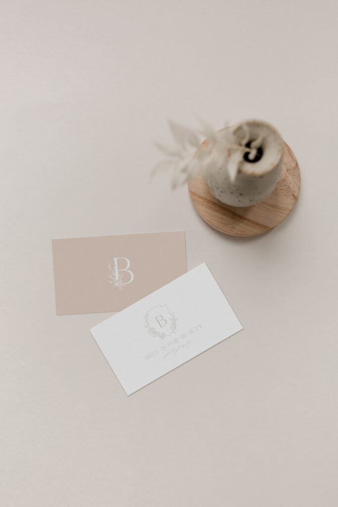 A custom logo for motherhood photographer Bree is for Beauty Photography—a crest logo with hand-drawn roses and a rose pattern.