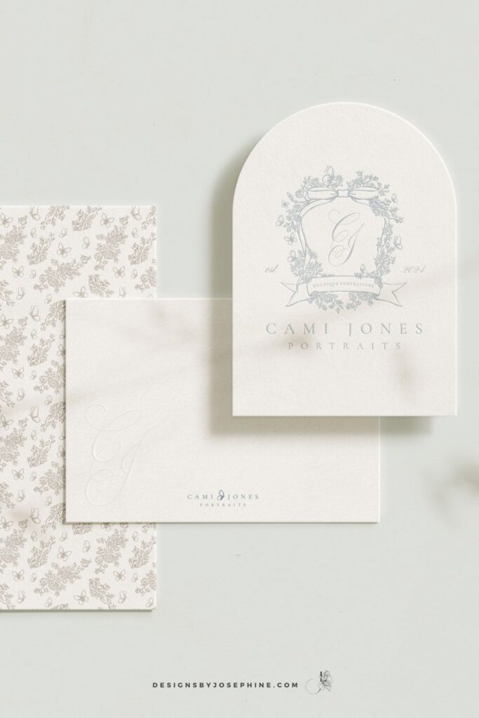 Elegant brand stationery design for Cami Jones Portraits featuring a soft blue floral crest logo, delicate bow illustration, and romantic neutral tones.